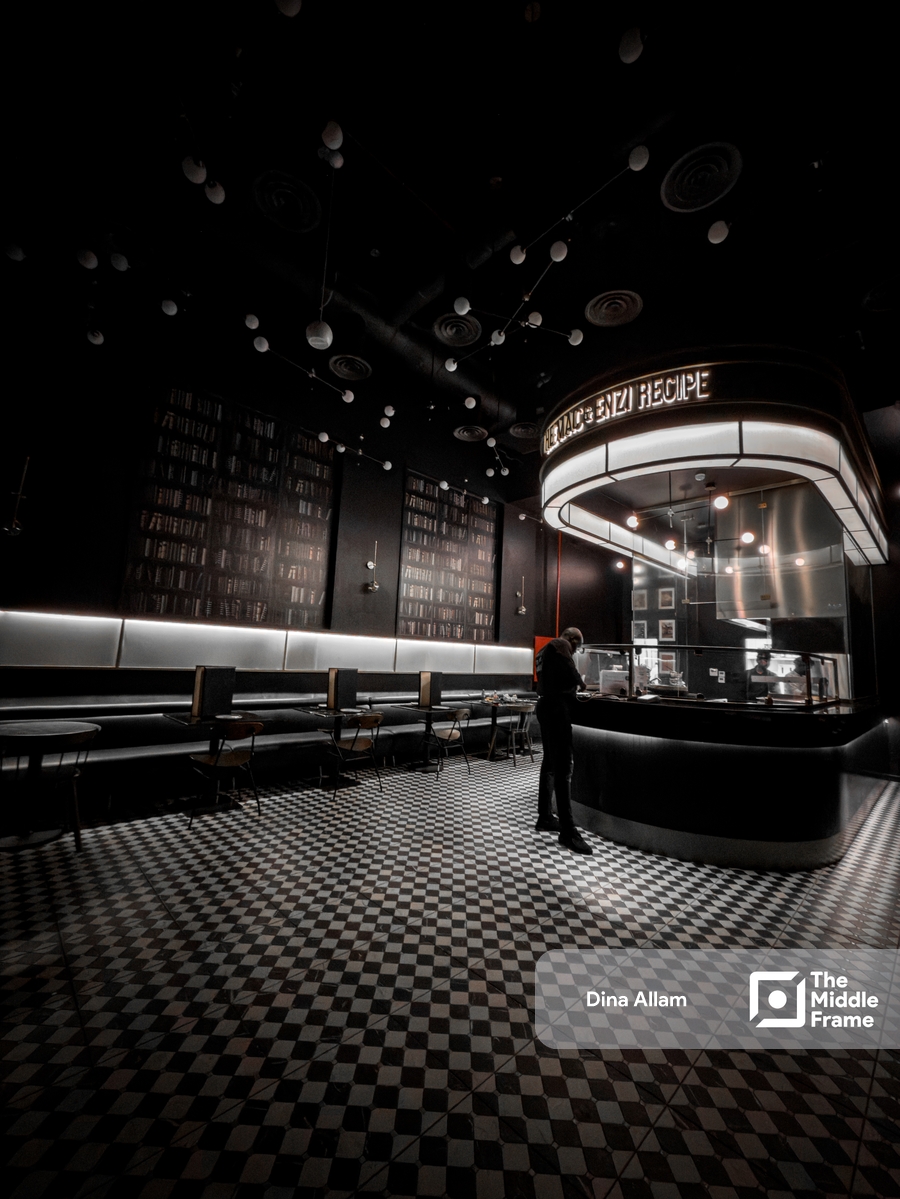 the interior of a restaurant with black and white checkered floor