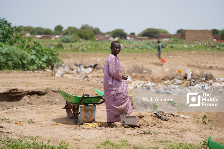 a woman in a purple dress is standing in the dirt