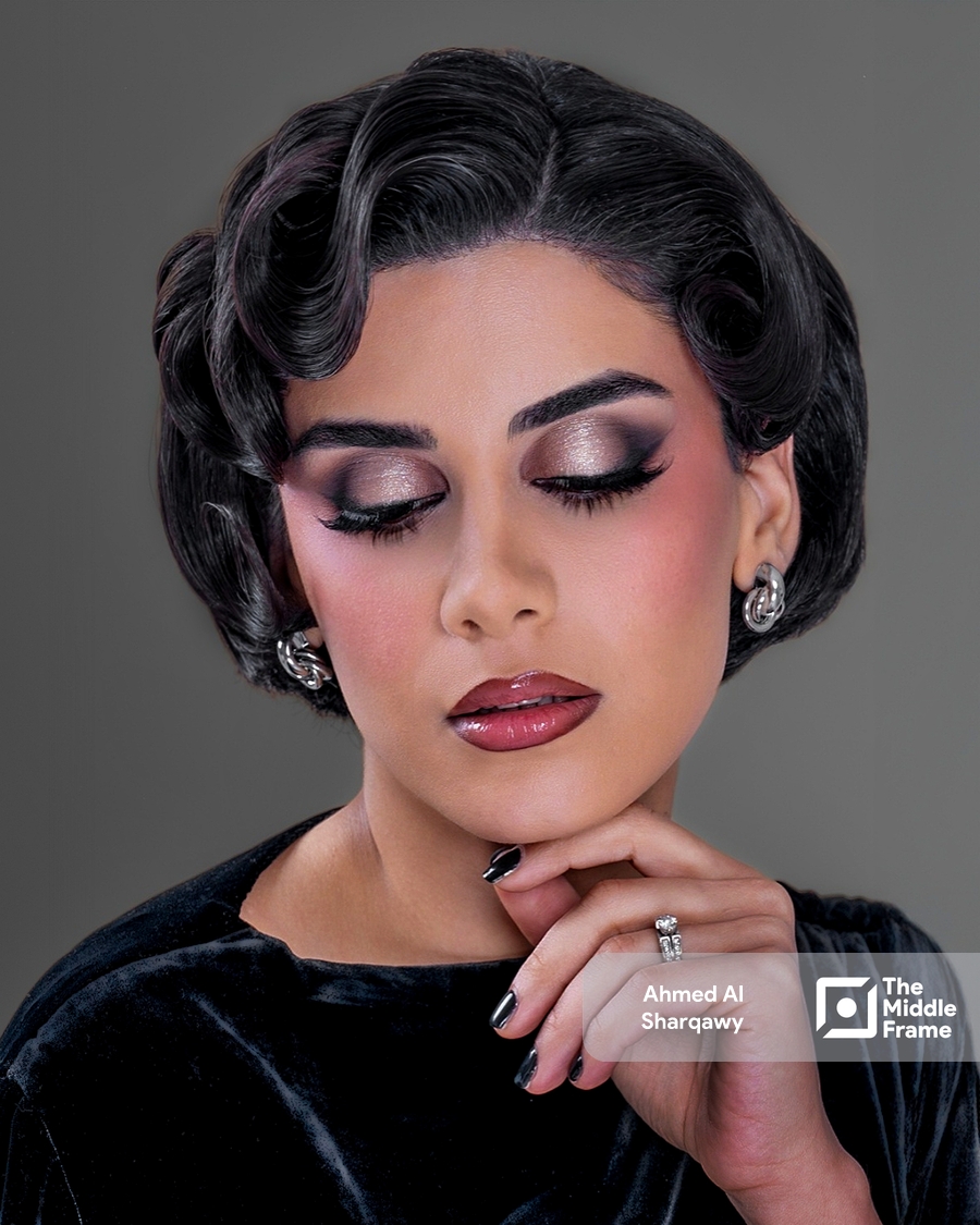 a woman with dark hair and a black dress