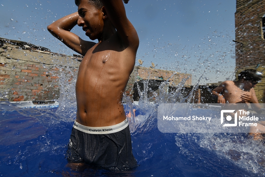 Children swimming in a pool in a traditional neighborhood in Egypt.