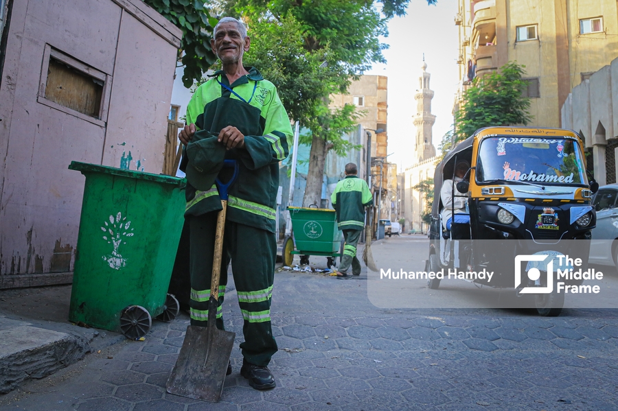 A cleaner standing in the street in Egypt