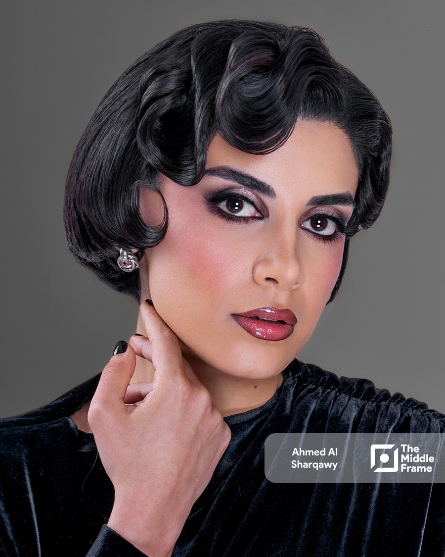 a woman with short hair and a black dress