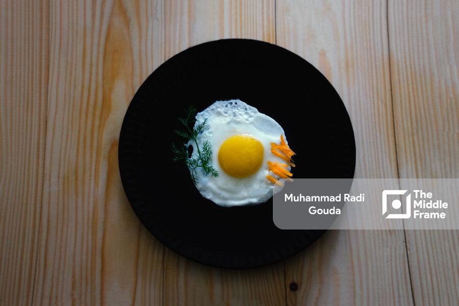A fried egg on a black plate