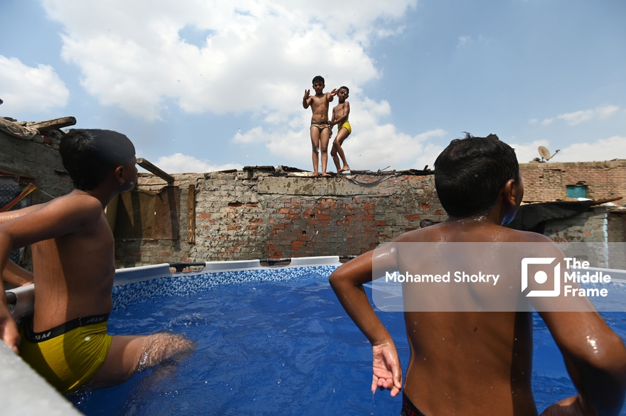 Children swimming in a pool in a traditional neighborhood in Egypt.