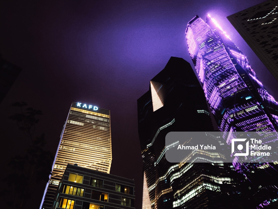 the skyscrapers lit up purple in the night sky in KAFD