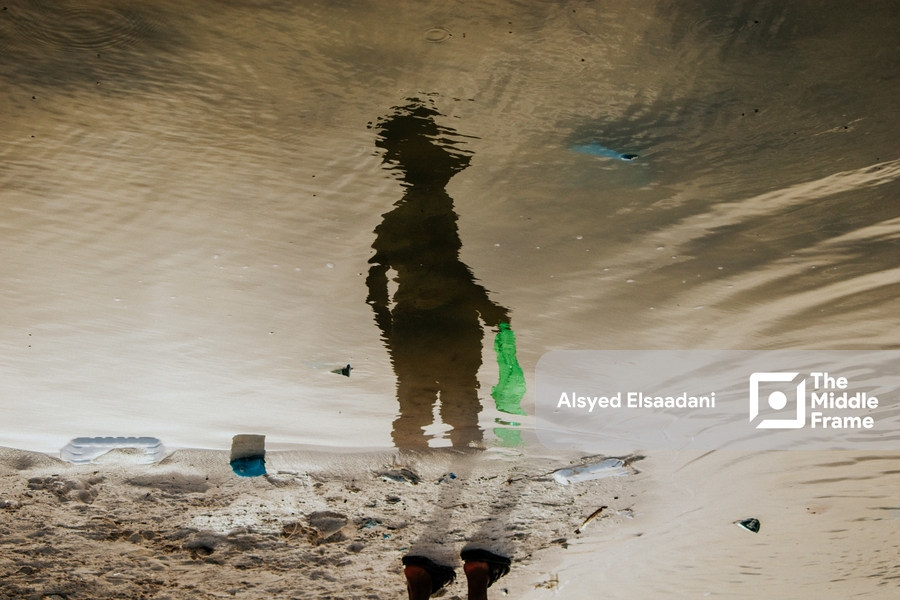 A man is reflected in the water