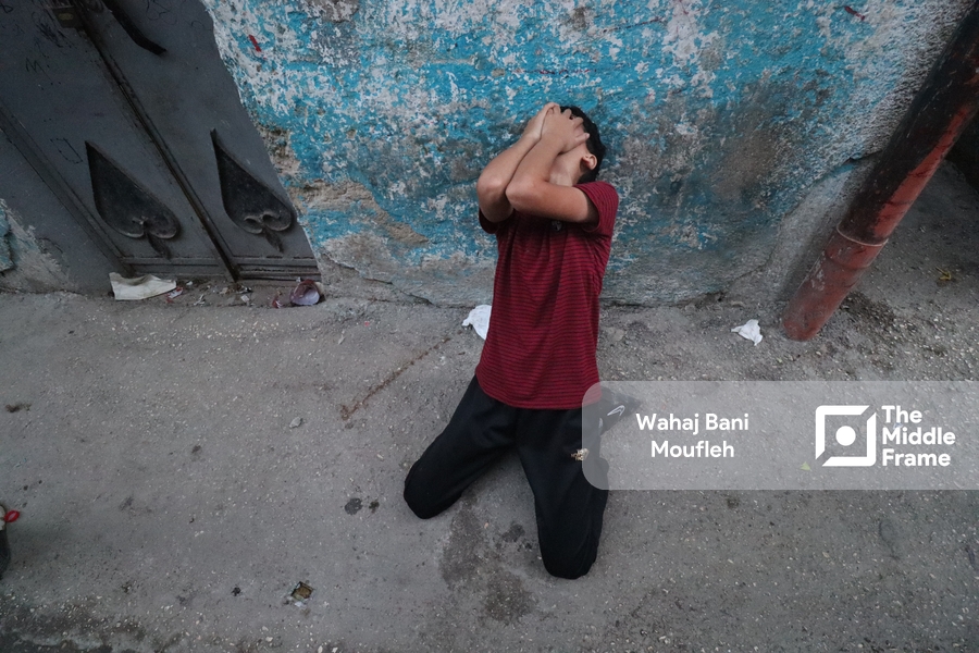 A Palestinian young man crying.