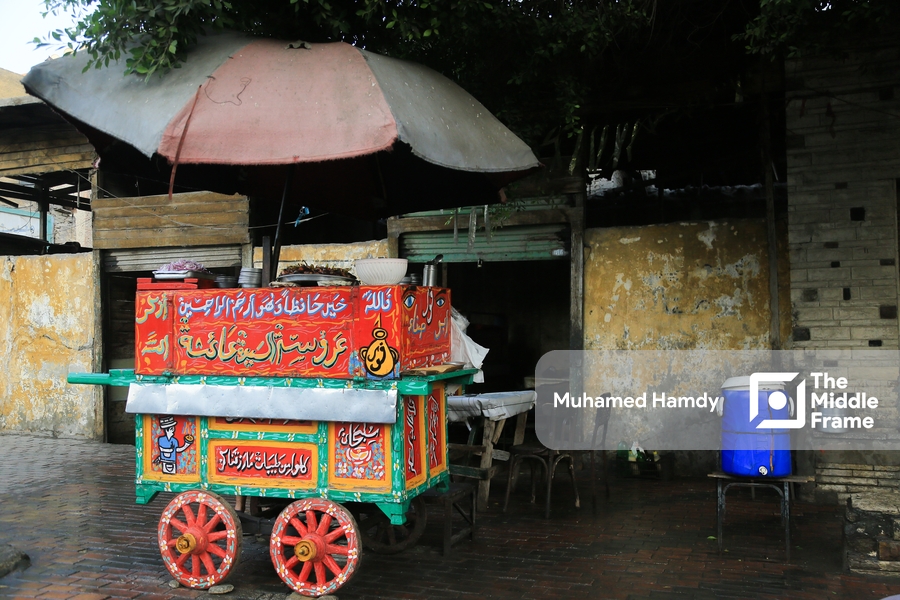 A street vendor's carrige with an umbrella blocking the sun in old Cairo, Egypt