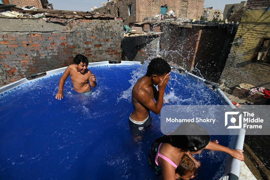 Children swimming in a pool in a traditional neighborhood in Egypt.