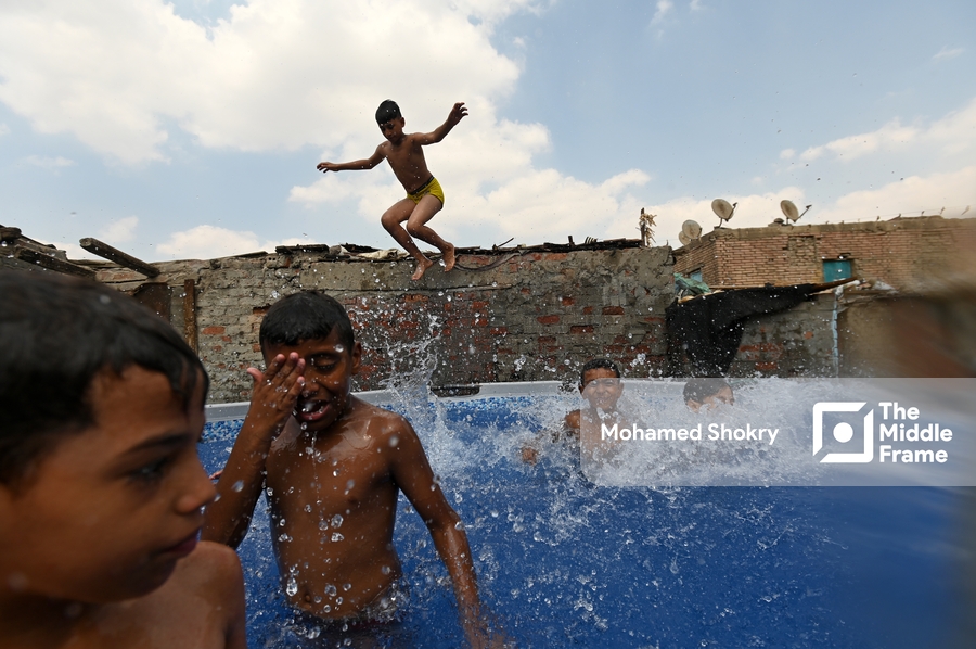 Children swimming in a pool in a traditional neighborhood in Egypt.