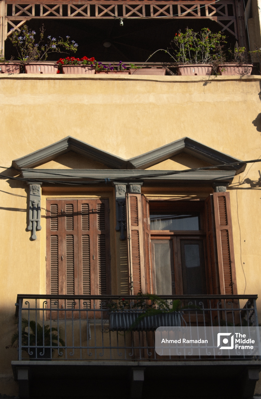 a balcony with flowers on the balcony