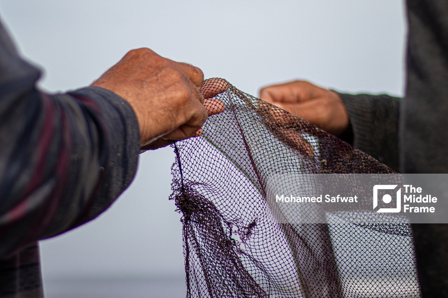 Fishermen fixing the fishing net in Kafr Elsheikh-Egypt.