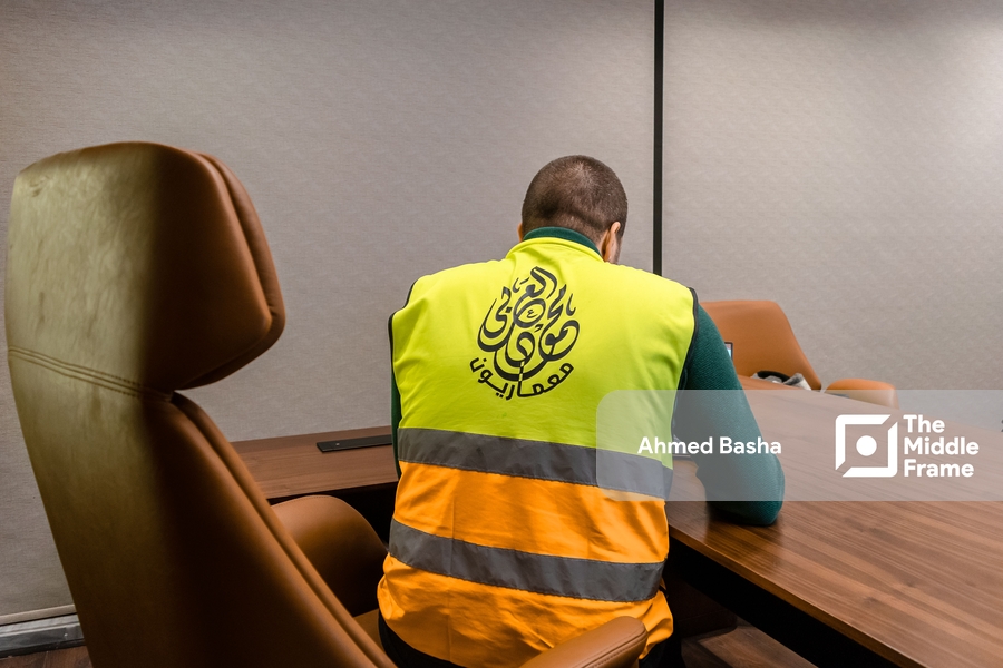 An Arab man turns his back to the camera