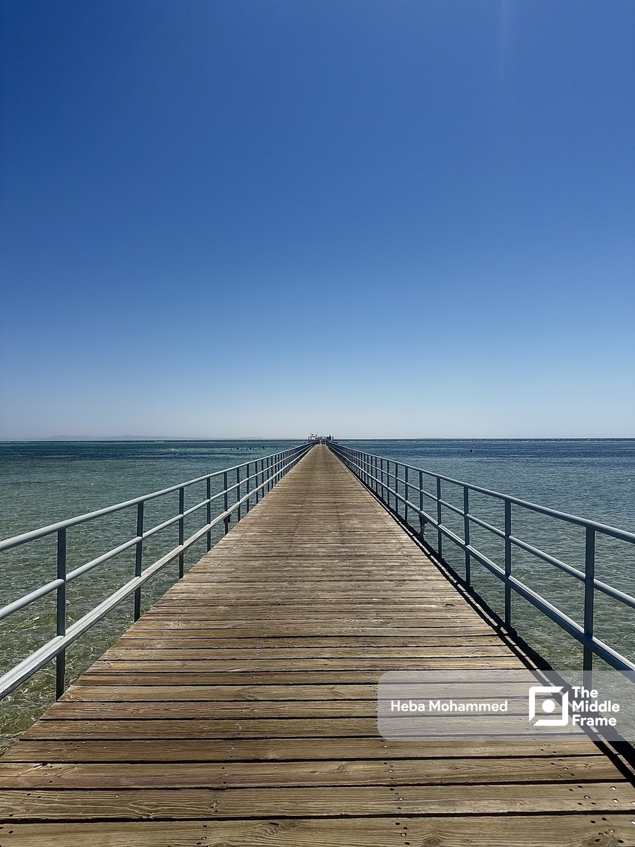 A beautiful picture of a deck leading to the horizon