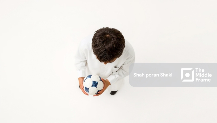 A Boy is holding a soccer ball