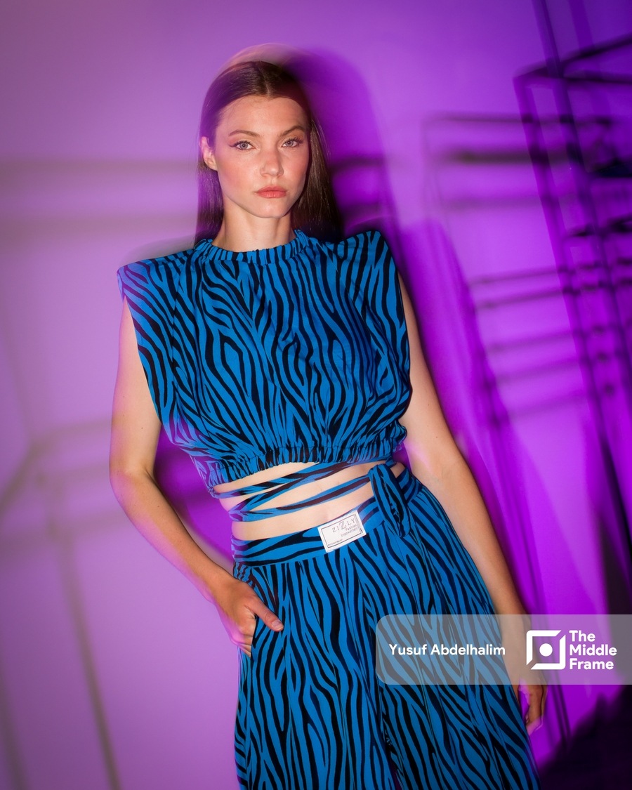 a model in a blue zebra print dress