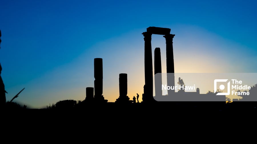 The sun setting behind the ruins