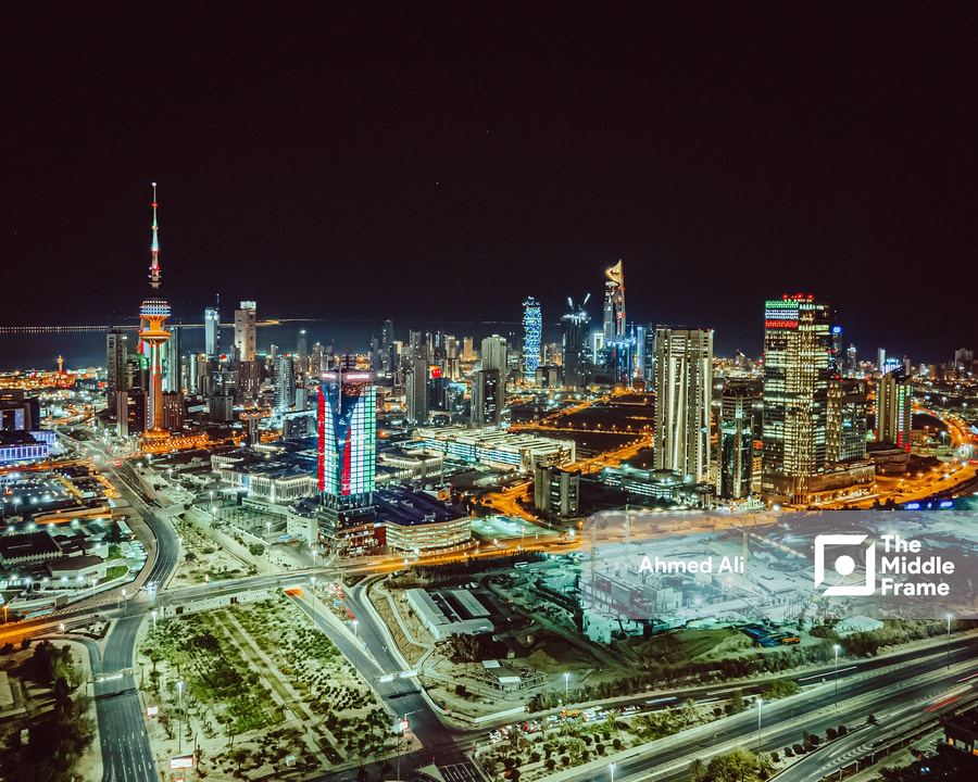 Kuwait Tower skyline glowing at night.