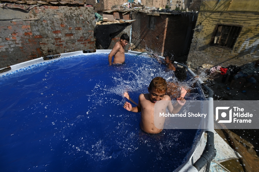 Children swimming in a pool in a traditional neighborhood in Egypt.