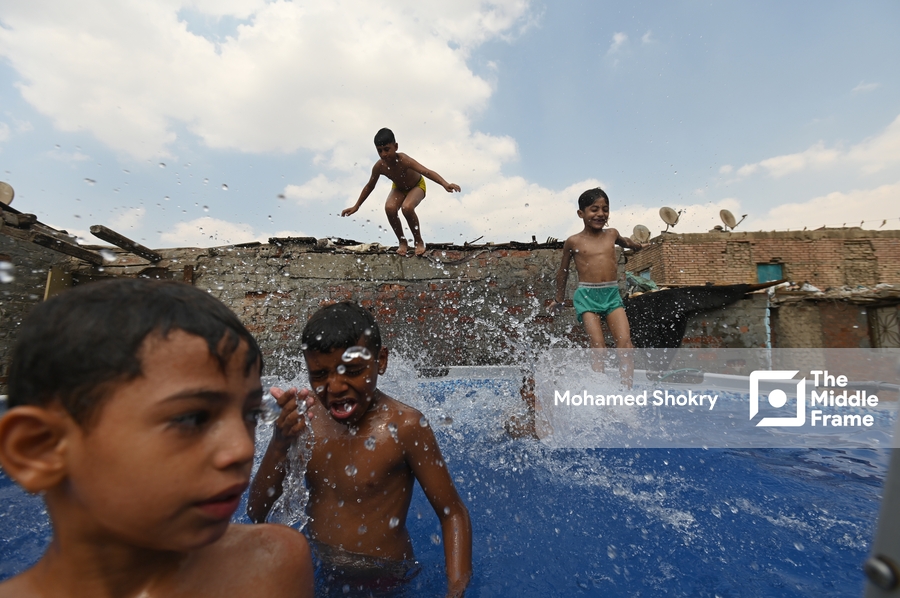 Children swimming in a pool in a traditional neighborhood in Egypt.
