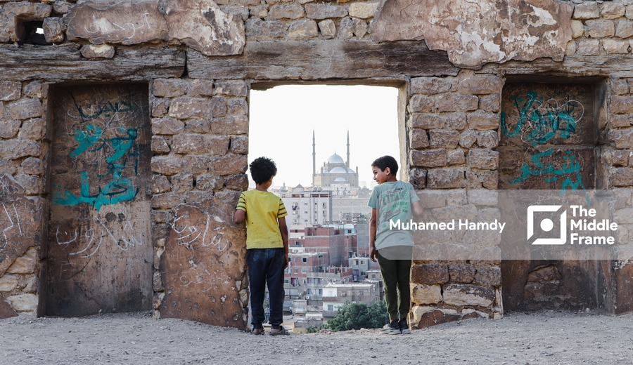 Two kids standing at a doorway