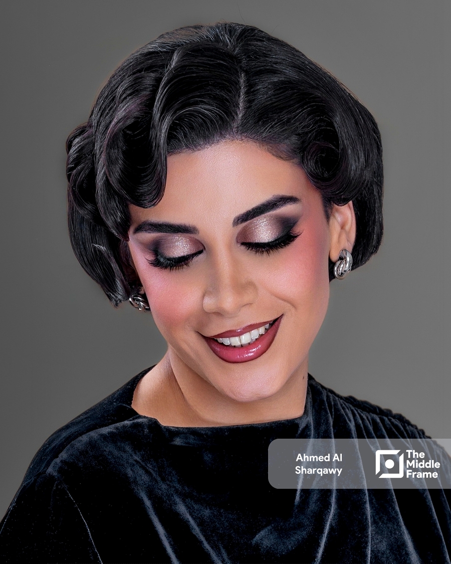 a woman with short hair and a black dress