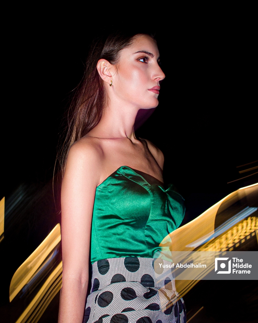 a female model in a green dress in runway
