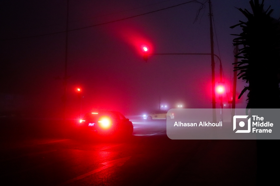 A car driving through a foggy night