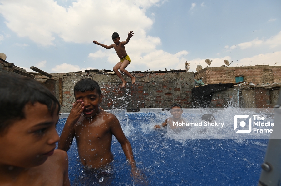 Children swimming in a pool in a traditional neighborhood in Egypt.