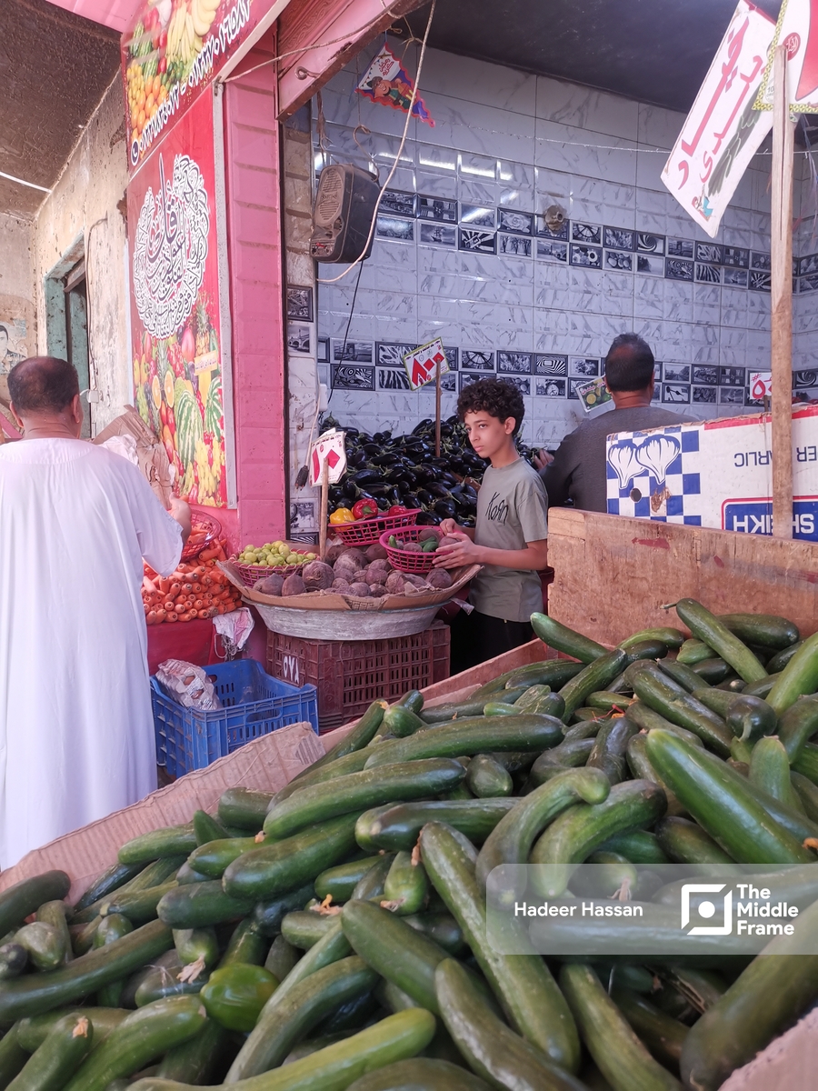 A teenager an two men selling vegetables in Egypt