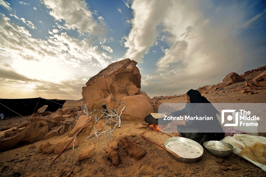 A woman making bread in the traditional way in the desert