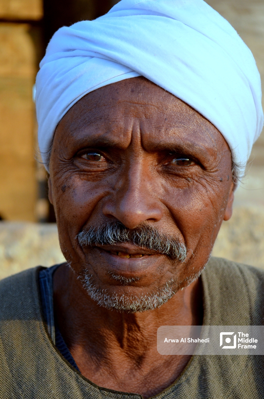 Portrait of a dark-skinned man from Upper Egypt in traditional clothing