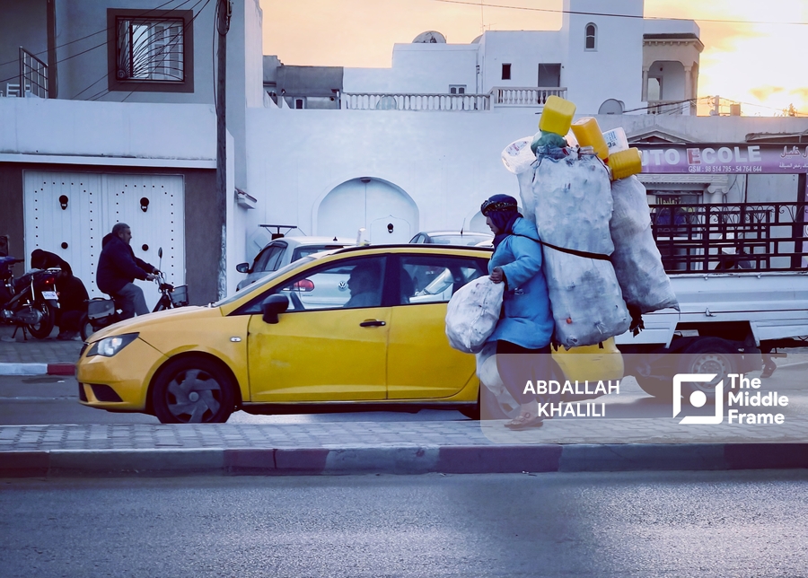 a man in a yellow car with a large bag on his back