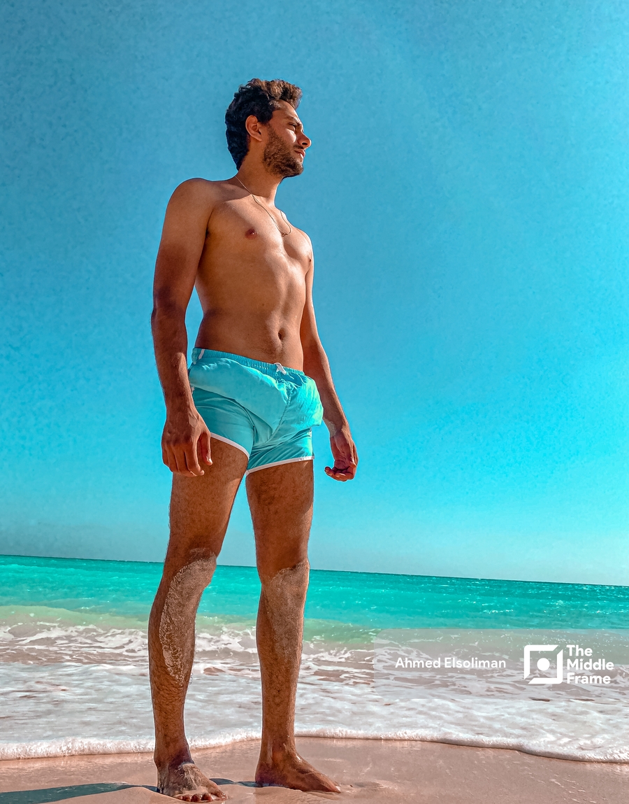 Young man standing at the beach