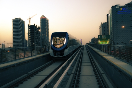 a train traveling through a city at dusk