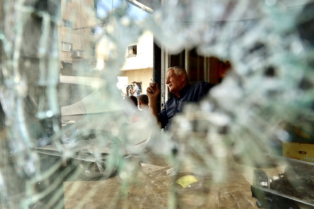 A Glimpse Through the Rubble: An Elderly Palestinian Facing Destruction.