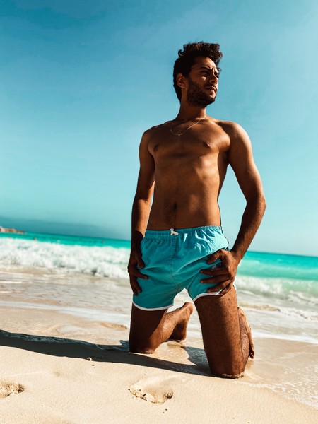 Young man sitting at the beach