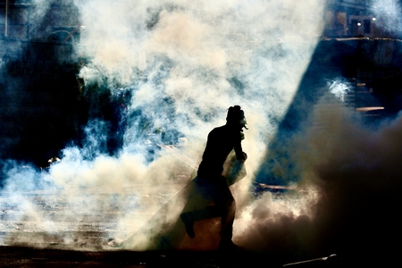Palestinian Flees Tear Gas During Israeli Military Operation in Jenin.