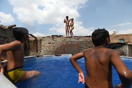 Children swimming in a pool in a traditional neighborhood in Egypt.