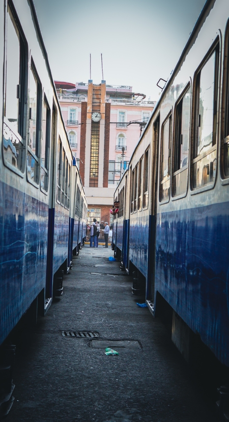 Two blue trains parked side by side