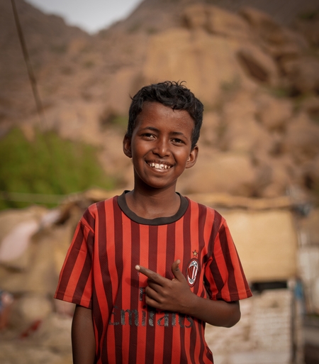 A portrait of a joyful Sudanese child.