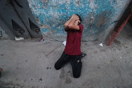 A Palestinian young man crying.