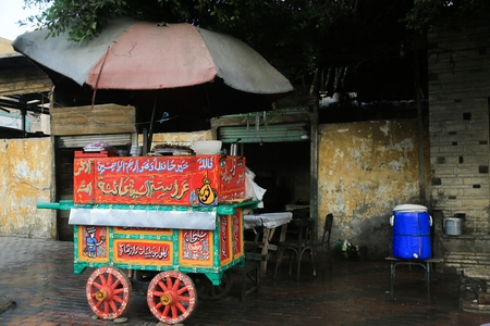 A street vendor's carrige with an umbrella blocking the sun in old Cairo, Egypt