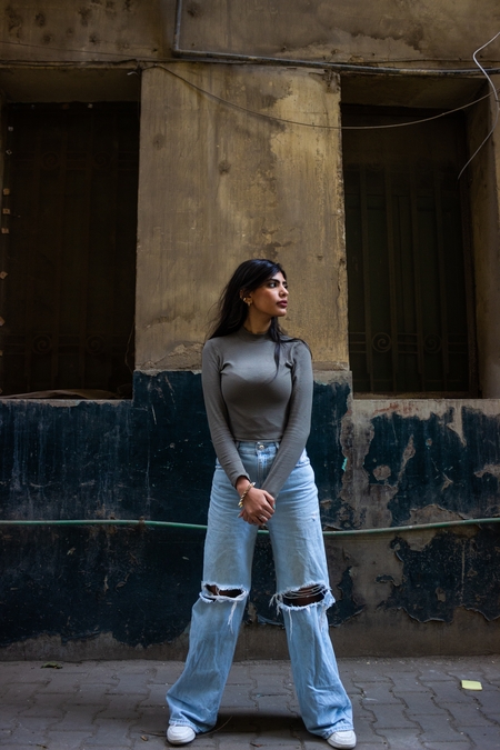 An Egyptian woman stands in the street