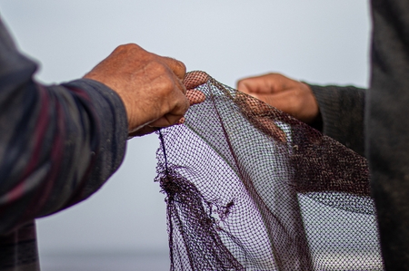 Fishermen fixing the fishing net in Kafr Elsheikh-Egypt.