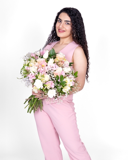 a woman in pink holding a bouquet of flowers