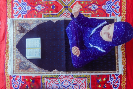A girl on a prayer rug.