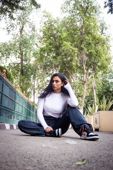 An Egyptian woman sitting on the ground outdoors