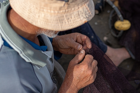 Fishermen fixing the fishing net in Kafr Elsheikh-Egypt.