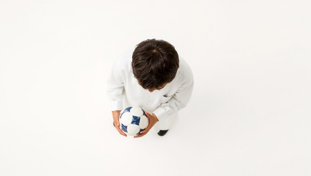 A Boy is holding a soccer ball